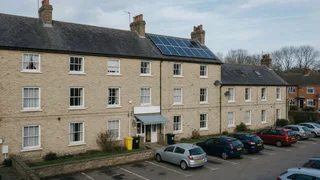 Typical UK provincial hotel with a modest rooftop solar array and car park