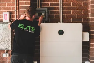 Description: A technical infographic illustrating the lifespan of a home battery, specifically for a UK household, with a focus on the realistic 10-15 year range. The diagram…